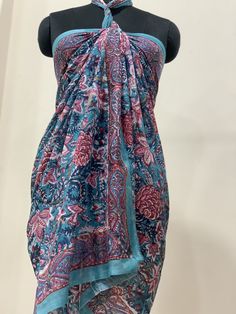 "Colorful, woodblock printed, cotton sarong, perfect for a day by the shore or to lounge in comfort at home. Wrap it in a variety of ways, as a beach dress (see photo), or around the waist, or simply use it to lie on at the beach. A versatile addition to any wardrobe! Measures 44\" x 72\"(180cm x110cm ) *Made of 100% cotton. *Hand Block printed *Machine wash on warm/cold *Production Capacity: 1000 Naturally occurring dye variations are found on all hand printed textiles, making each piece unique Blue Printed Dupatta For Summer, Multicolor Block Print Sarong For Beach Cover-up, Bohemian Cotton Patterned Sarong, Bohemian Multicolor Cotton Sarong, Bohemian Patterned Cotton Sarong, Traditional Cotton Shawl For Beach, Multicolor Cotton Sarong For Beach Cover-up, Multicolor Cotton Sarong For Beachwear, Bohemian Cotton Sarong With Block Print