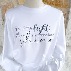 a white sweatshirt with the words, this little light of mine i'm going to shine on it