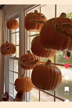 pumpkins are hanging from the windows with faces carved into them