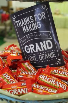 a basket filled with lots of candy sitting on top of a table next to a sign that says thanks for making