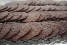 some cookies are cooling on a rack and ready to be baked in the oven for consumption