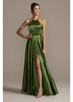 a woman in a green dress posing for the camera