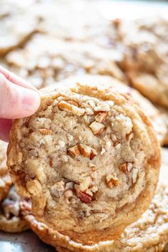 a close up of a person holding a cookie