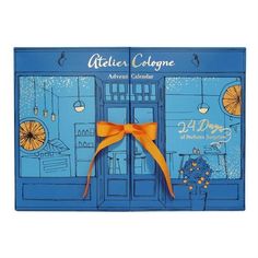 a blue box with an orange bow on it's front and the words atelier cologne