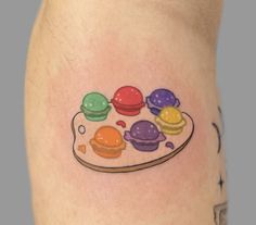 an image of a colorful tattoo on the side of a woman's leg that has different colored ice creams on it