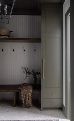 a bench and coat rack in a room