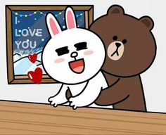 a bear and bunny hugging each other in front of a window with the words i love you written on it