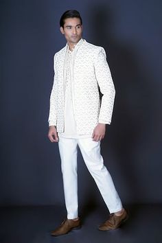 Ivory jacket with geometric pattern stone hand embroidery. Comes with bundi style vest with gold mirror and gota work, and an ivory kurta with embroidered with self on self thread work. Paired with a pant. - Aza Fashions Designer White Embroidered Outerwear, Formal White Embroidered Outerwear, Traditional White Outerwear With Resham Embroidery, White Long Sleeve Ceremonial Outerwear, White Chikankari Embroidered Outerwear For Wedding, White Chikankari Embroidery Outerwear For Wedding, Designer Long Sleeve Bandhgala With Pearl Embroidery, Designer Bandhgala With Pearl Embroidery And Long Sleeves, White Long Sleeve Designer Bandhgala