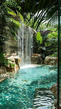 an outdoor swimming pool with waterfall in the middle