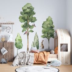 a child's room with trees and animals painted on the wall