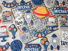 some cookies are decorated with space related designs and words that spell out the name of each astronaut