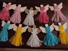 the paper angels are decorated with colorful tassels