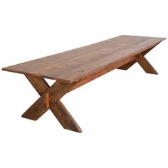 a wooden table with two x legs on the top and one leg extended to the side