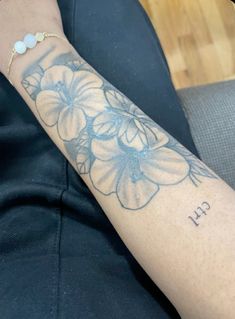 a person with a flower tattoo on their arm