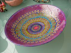 a colorful bowl sitting on top of a table