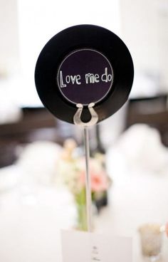 a black hat with the word love me do on it sitting on top of a table