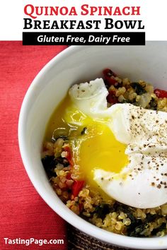 quinoa spinach breakfast bowl with fried eggs in it on a red cloth