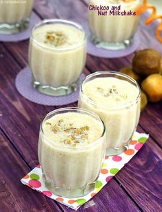 three glasses filled with pudding sitting on top of a table