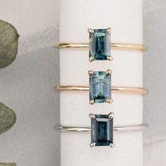 three rings with different colored stones on them