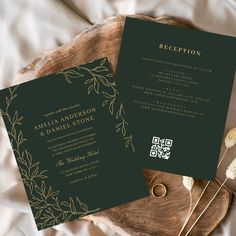 two wedding cards on top of a wooden plate