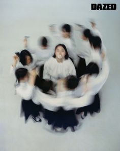 a group of people standing around each other in the middle of a circular photo with blurry images