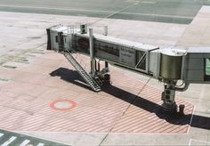 an airplane is parked on the tarmac with stairs leading up to it's door