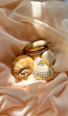 VINTAGE SEASHELL CHARM Quantity: 1 Charm -Select Shell Option In Drop Down Menu ITEM DESCRIPTION This listing is for a vintage seashell charm - while quantities last there are four options to choose from (Moon Shell, olive shell, and a larger or smaller cockle shell). Each shell has luxurious 24kt gold plated detail. I have added a sturdy gold tone metal jump ring to each charm. These would be appropriate to wear on a necklace pendant or as part of a charm necklace. The olive shells and the moon Gold Strand Shell For Vacation, Handmade Gold Shell With Beachy Style, Vintage Gold Beach Jewelry, Gold Shell With Beachy Style For Vacation, Vintage Gold Shell Gift, Vintage Gold Shell As A Gift, Vintage Gold Shell As Gift, Gold Beachy Shell For Vacation, Beachy Gold Shell For Vacation