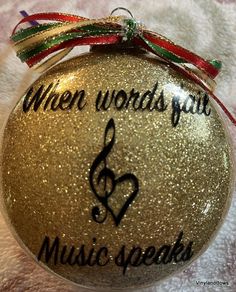 a gold ornament with music speaks written on it