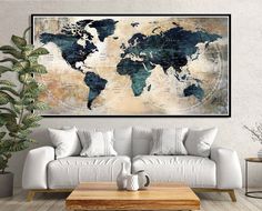 a living room with a couch, coffee table and large map on the wall above it