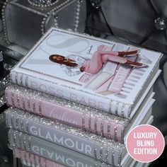 three books stacked on top of each other with the covers pulled back and sequins around them