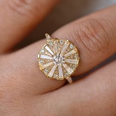 a woman's hand with a yellow gold ring and diamond set in the middle