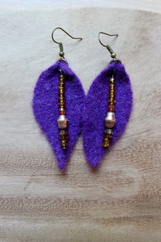 purple felt earrings with beads on them