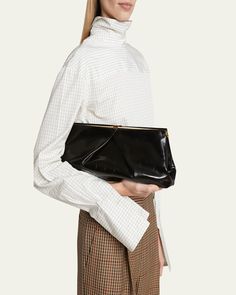 Dries Van Noten clutch bag in calf leather, nylon/polyamide, and polyurethane     Structured top with snap closure     Interior, one slip pocket     Approx. 16.1"W x 5.9"H x 3.9"D    Imported Structured Top, Metallic Clutch, Leather Clutch Bag, Small Clutch, Envelope Clutch, Leather Clutch Bags, Dries Van Noten, Leather Clutch, Snap Closure