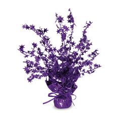 a purple vase filled with flowers on top of a white table