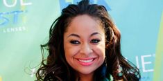 a woman with long hair smiling at the camera