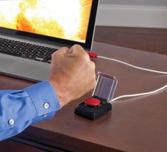 a man is playing an interactive video game on his laptop computer while sitting at a desk