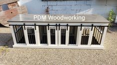 a dog kennel with the words pdm woodworking on it's side