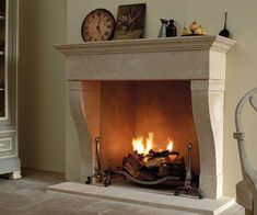 a fire place in a living room with a clock on the top shelf above it