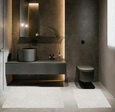 a bathroom with a toilet, sink and mirror