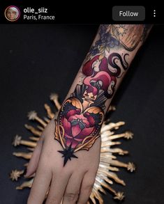 a person's hand with a tattoo on it and gold stars around the wrist