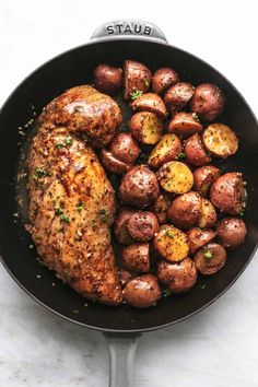 chicken and potatoes in a skillet on a marble countertop with the word, state written