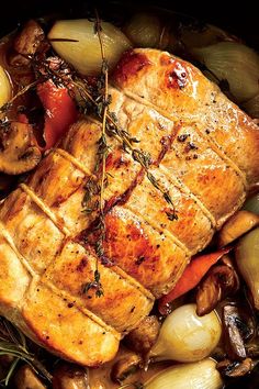 meat and vegetables in a skillet with herbs