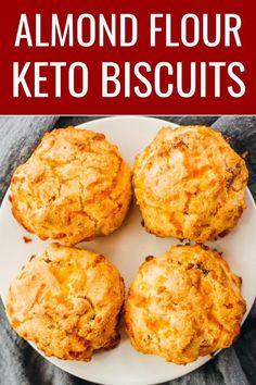 four biscuits on a white plate with the words almond flour keto biscuits above it