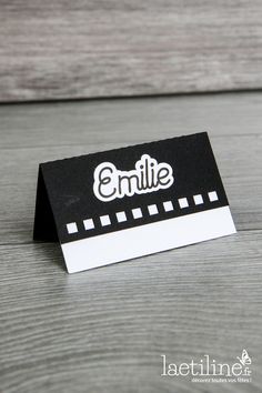 a small black and white business card with the word smile on it's side