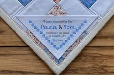 a close up of a wedding handkerchief on a wooden surface