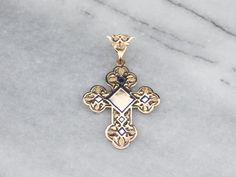 Beautiful enough to wear as a bridal piece, this vintage cross features ornate filigree, royal blue enamel details, and perfect polish, making this piece ready to wear or gift! This pendant does not come with the chain shown. Please feel free to contact us, we will help you find the perfect chain for your style and budget!Metal: 14K Yellow GoldMaterial: Blue Enamel Measures: 30 x 48 mm, with bailMarks: "585" Stamped on the reverse Luxury Ornate Cross Pendant Necklace, Enamel Cross, Gold Filigree, Gold Cross, Religious Jewelry, Religious Gifts, Hand Engraving, Gold Material, Vintage Gold