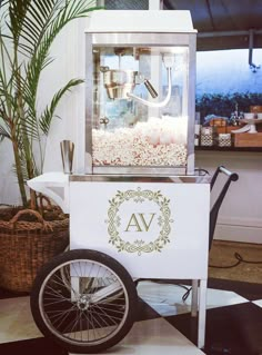 an old fashioned popcorn vending machine with wheels