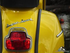 the rear end of a yellow scooter