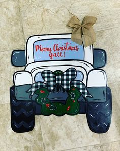 a christmas card with an image of a white truck and two green alligators on the front