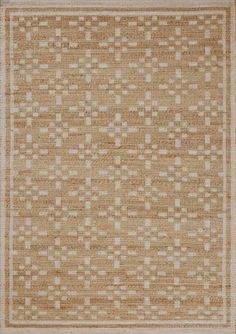 a beige and white rug with squares on the bottom, in an area that looks like it